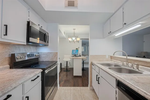 a kitchen with a sink stove and microwave