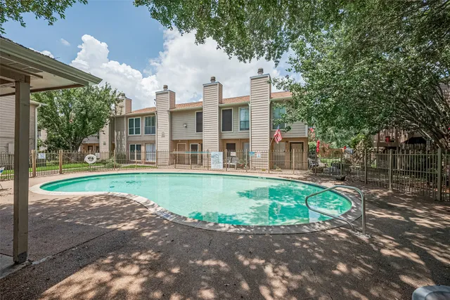 a view of a swimming pool with a patio