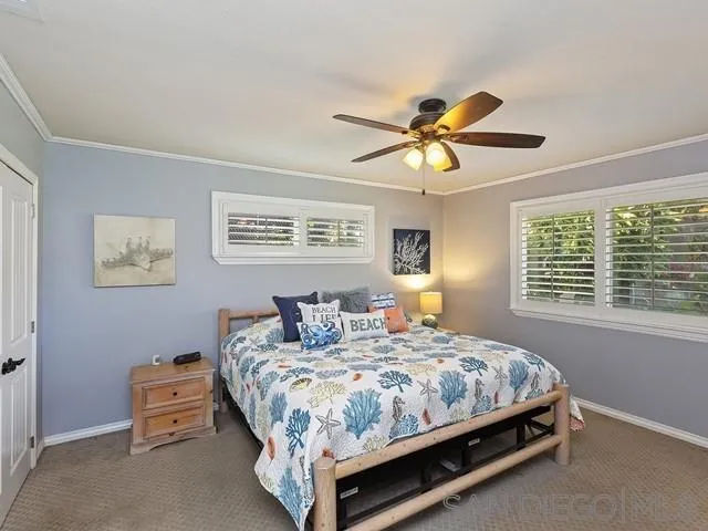 1528 Reche Road Fallbrook, CA 92028 - Photo 16 of 32 a bedroom with a bed and a chandelier