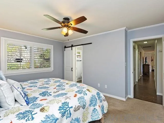 1528 Reche Road Fallbrook, CA 92028 - Photo 17 of 32 a bedroom with a bed and a chandelier