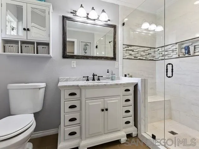 1528 Reche Road Fallbrook, CA 92028 - Photo 18 of 32 a bathroom with a double vanity sink mirror and toilet