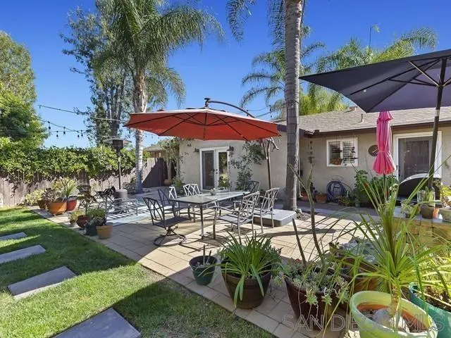 1528 Reche Road Fallbrook, CA 92028 - Photo 29 of 32 a view of a patio with table and chairs under an umbrella