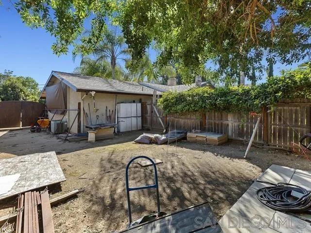 1528 Reche Road Fallbrook, CA 92028 - Photo 31 of 32 a view of backyard with seating space and trees in the background
