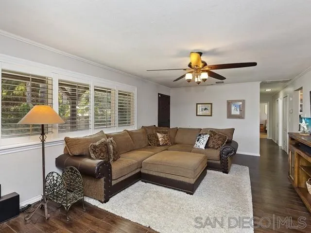 1528 Reche Road Fallbrook, CA 92028 - Photo 7 of 32 a living room with furniture and a chandelier