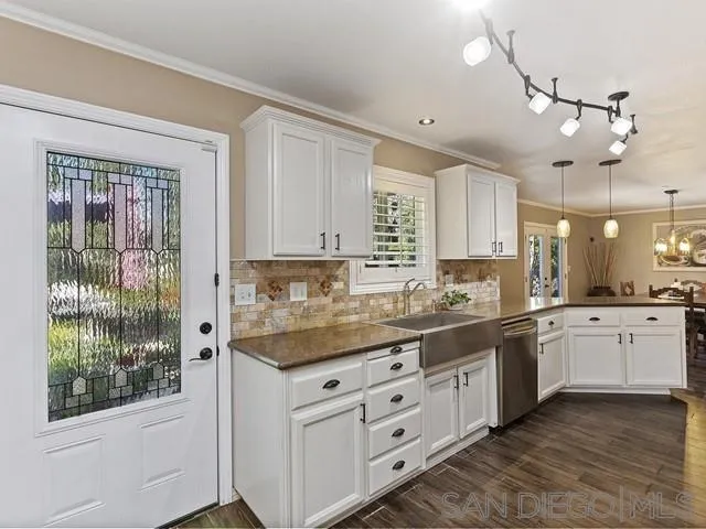 1528 Reche Road Fallbrook, CA 92028 - Photo 8 of 32 a kitchen with granite countertop white cabinets and white appliances
