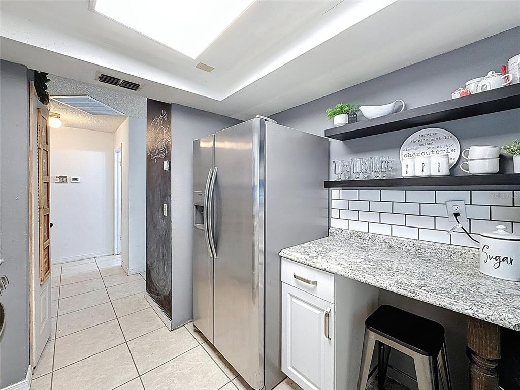Undisclosed Address Spring Hill, FL 34608 - Photo 14 of 54 a kitchen with stainless steel appliances granite countertop a sink and a refrigerator