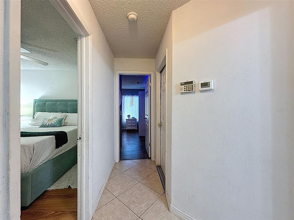 Undisclosed Address Spring Hill, FL 34608 - Photo 16 of 54 a view of a hallway and a livingroom with wooden floor