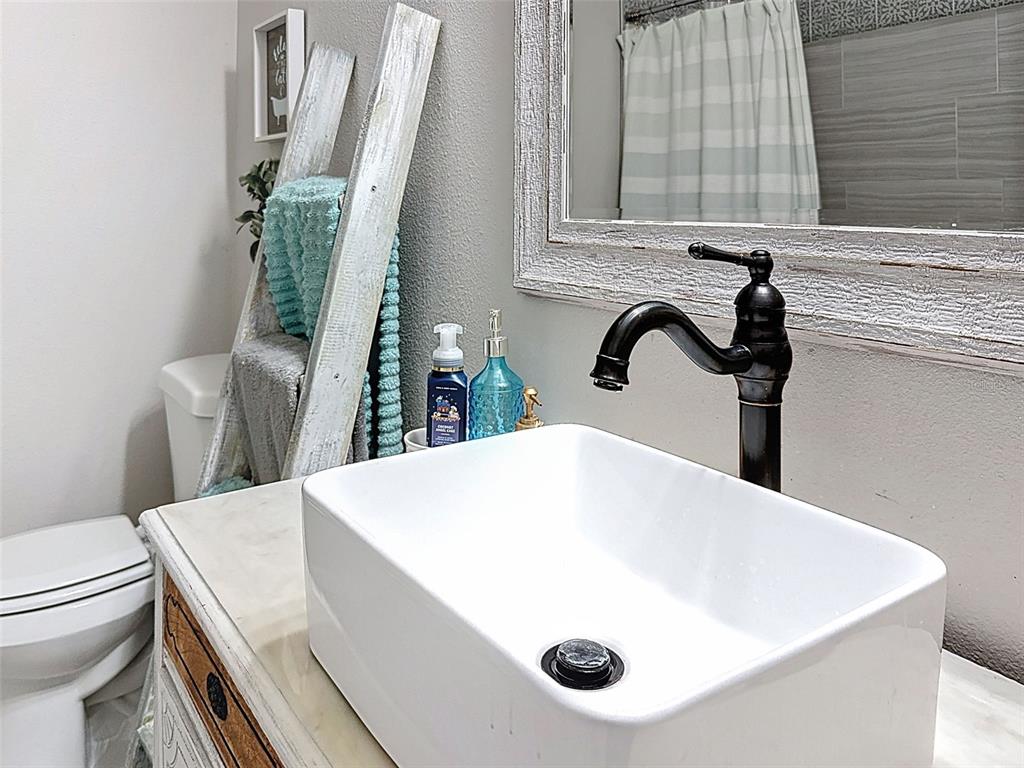 Undisclosed Address Spring Hill, FL 34608 - Photo 18 of 54 a bathroom with a sink and a toilet