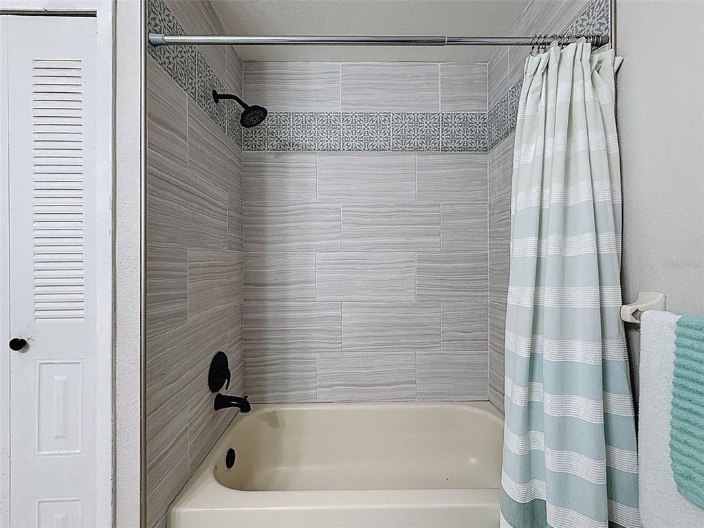 Undisclosed Address Spring Hill, FL 34608 - Photo 20 of 54 a bathroom with a bathtub and a shower