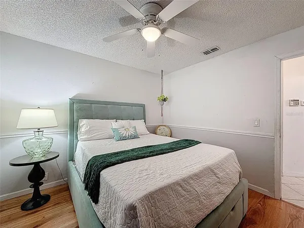 a bedroom with a bed and a chandelier