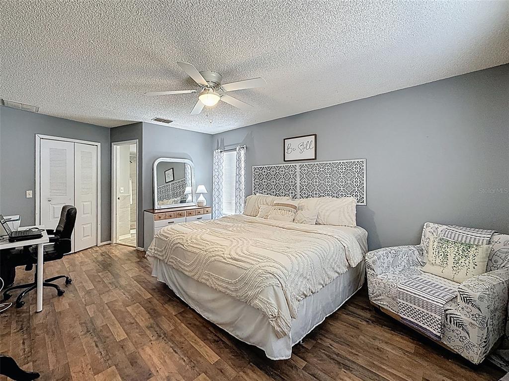 Undisclosed Address Spring Hill, FL 34608 - Photo 27 of 54 a bedroom with a bed and a desk