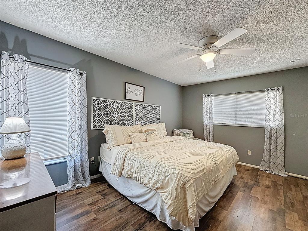 Undisclosed Address Spring Hill, FL 34608 - Photo 28 of 54 a bedroom with a bed and a flat tv screen on dresser