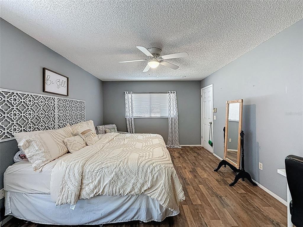 Undisclosed Address Spring Hill, FL 34608 - Photo 29 of 54 a bedroom with a bed and a chandelier