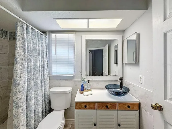 a living room with furniture a window and a table