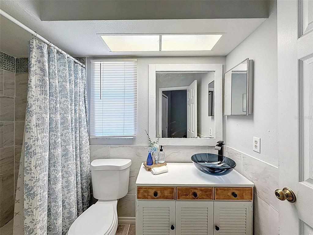 Undisclosed Address Spring Hill, FL 34608 - Photo 30 of 54 a bathroom with a sink mirror vanity and toilet