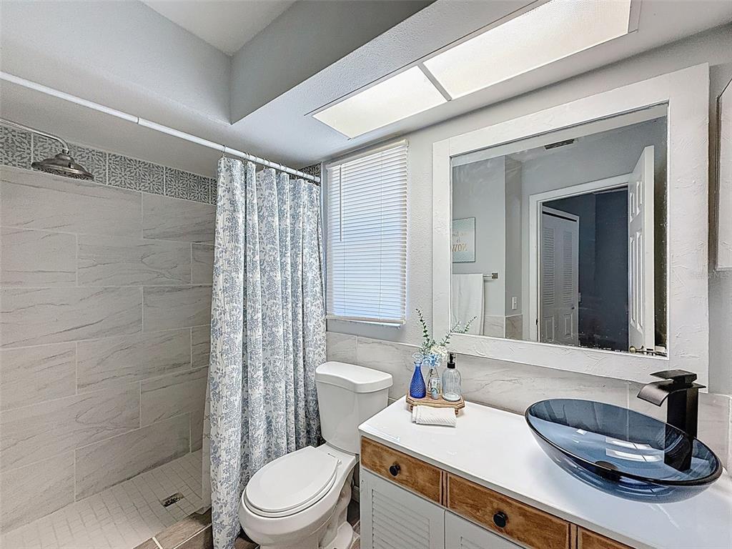 Undisclosed Address Spring Hill, FL 34608 - Photo 31 of 54 a bathroom with a sink a toilet and shower