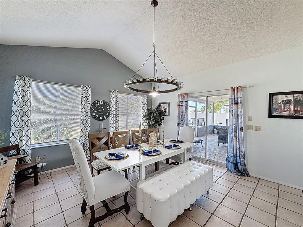 Undisclosed Address Spring Hill, FL 34608 - Photo 34 of 54 a dining room with furniture a chandelier and window