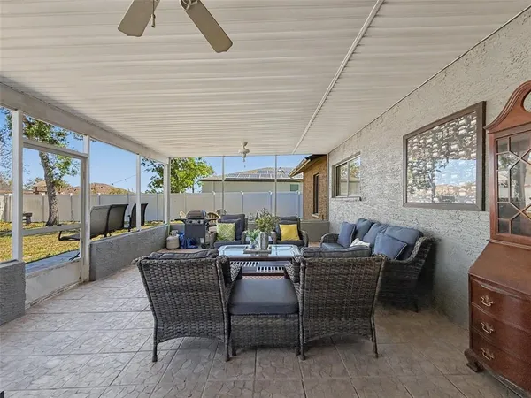 a view of backyard with swimming pool and furniture