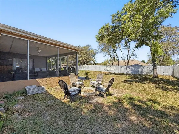 a front view of a house with swimming pool and porch with furniture
