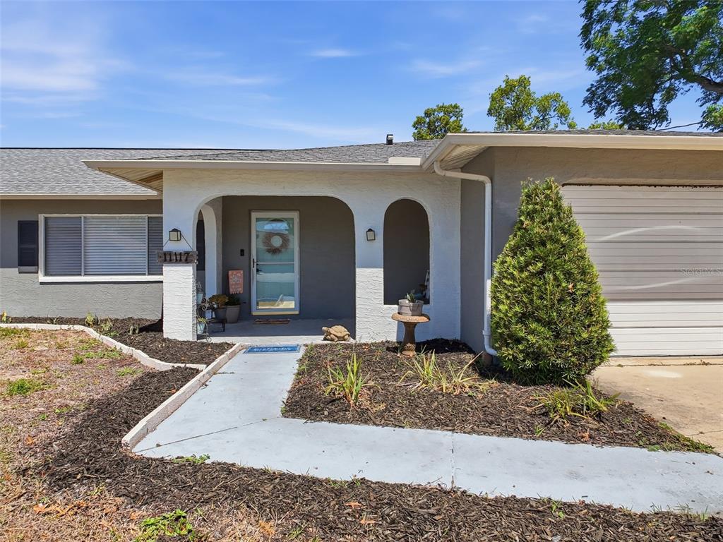 Undisclosed Address Spring Hill, FL 34608 - Photo 4 of 54 a view of a house with a yard
