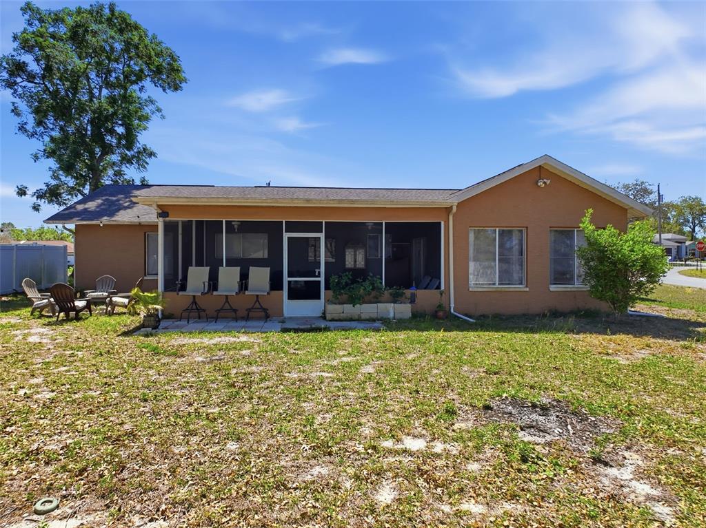 Undisclosed Address Spring Hill, FL 34608 - Photo 44 of 54 a front view of a house with swimming pool and porch with furniture