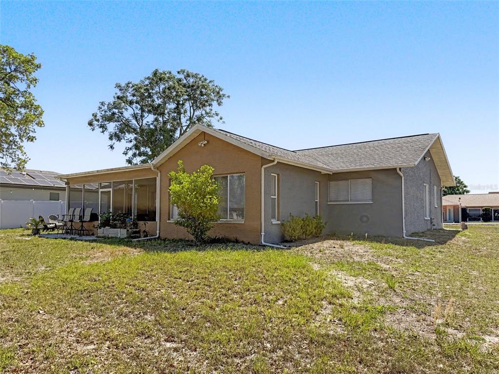 Undisclosed Address Spring Hill, FL 34608 - Photo 45 of 54 a view of a house with a yard and a large tree