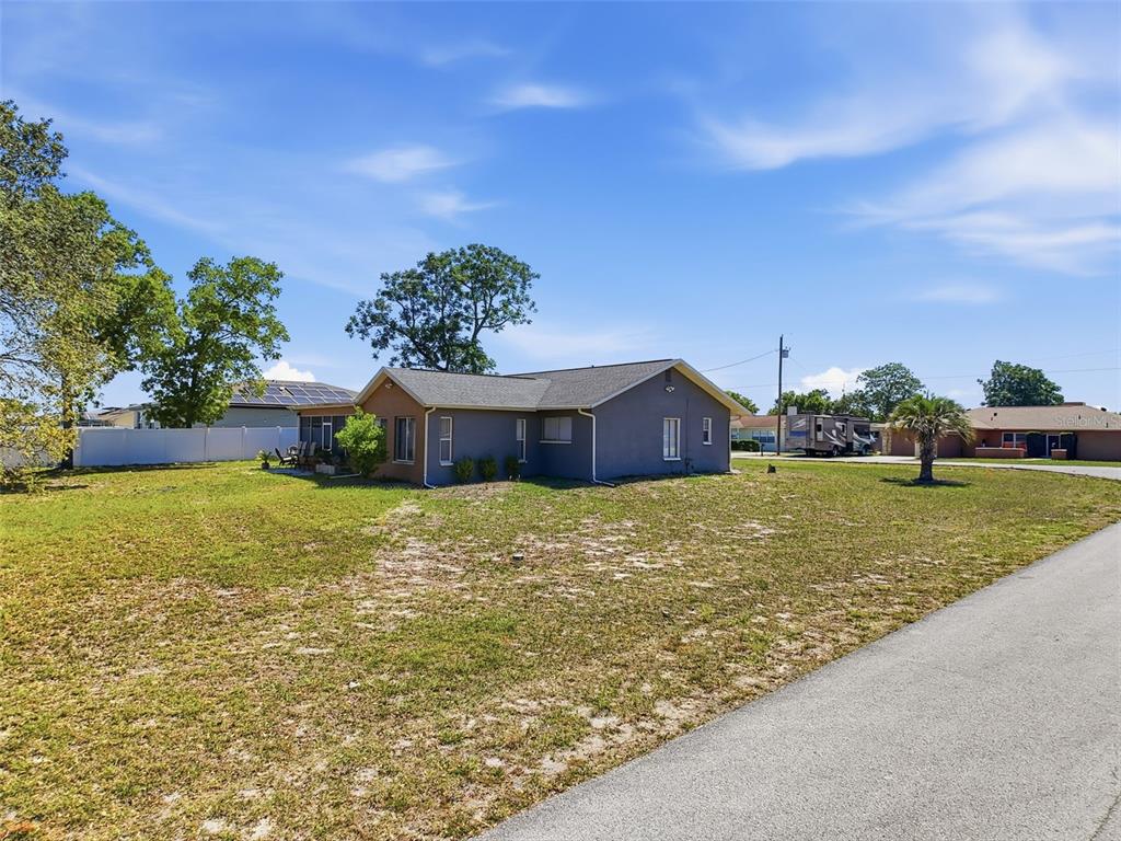 Undisclosed Address Spring Hill, FL 34608 - Photo 48 of 54 a tall yellow building in the middle of a field