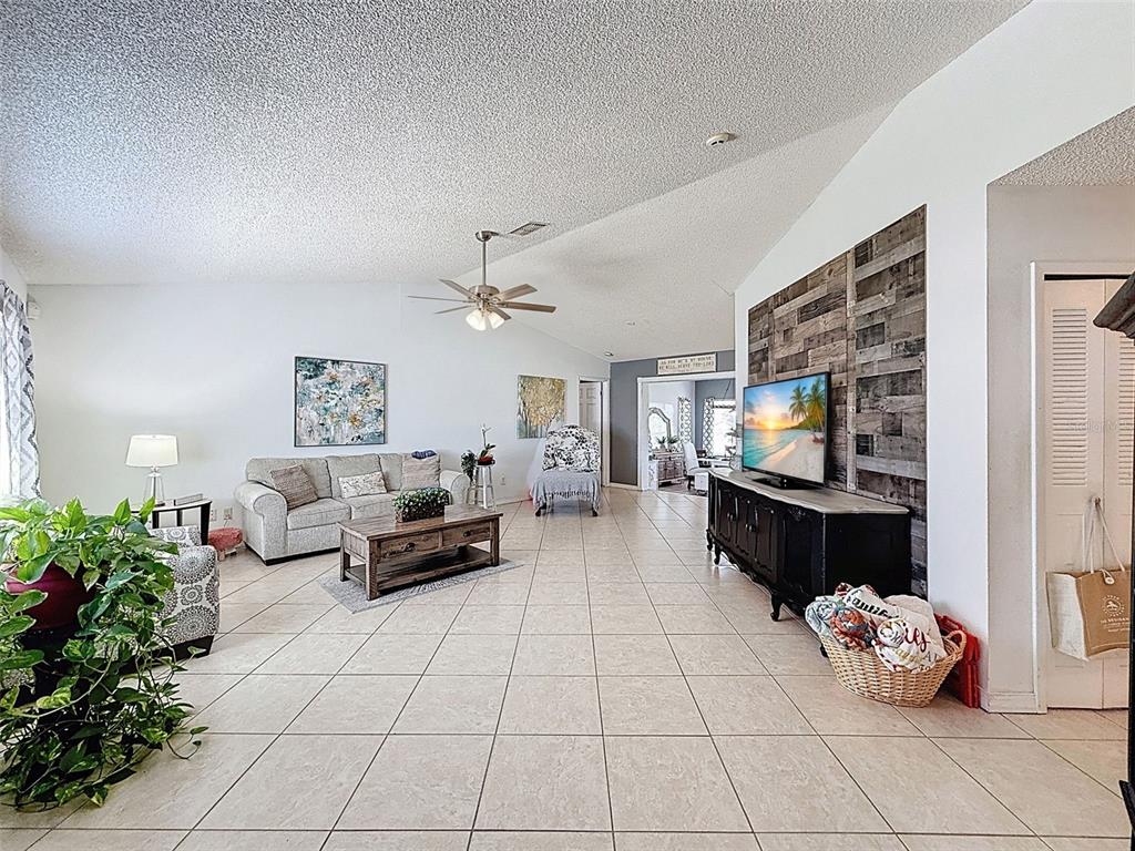 Undisclosed Address Spring Hill, FL 34608 - Photo 8 of 54 a living room with furniture and a flat screen tv