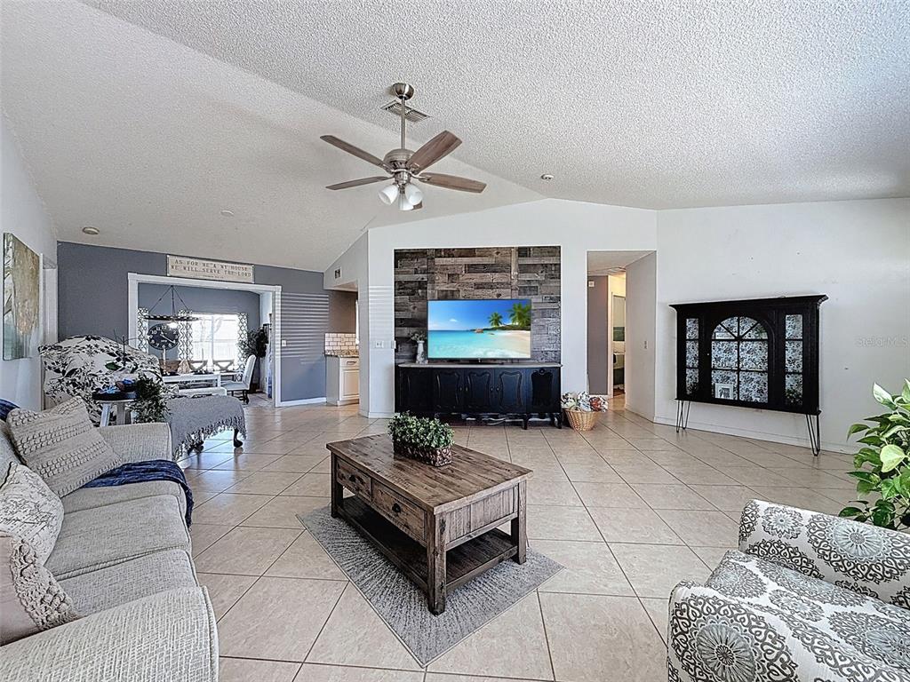 Undisclosed Address Spring Hill, FL 34608 - Photo 9 of 54 a living room with furniture and a flat screen tv