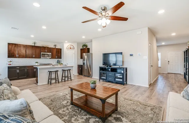 a living room with fireplace furniture and a flat screen tv