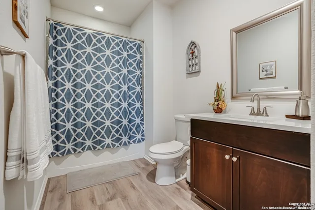 a bathroom with a sink toilet and a mirror