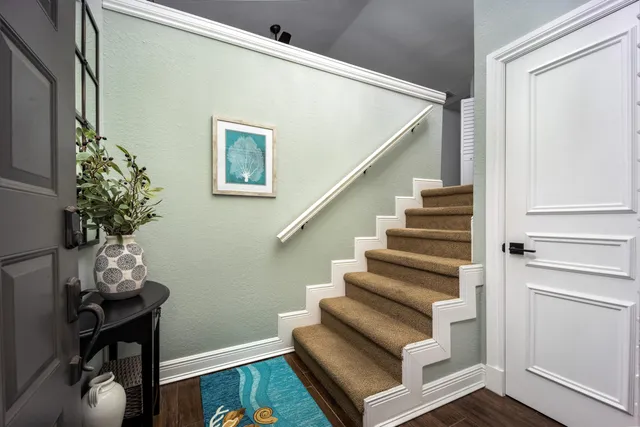 a view of entryway with wooden floor and stairs