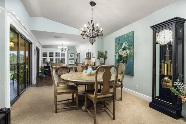 a view of a dining room with furniture and a chandelier