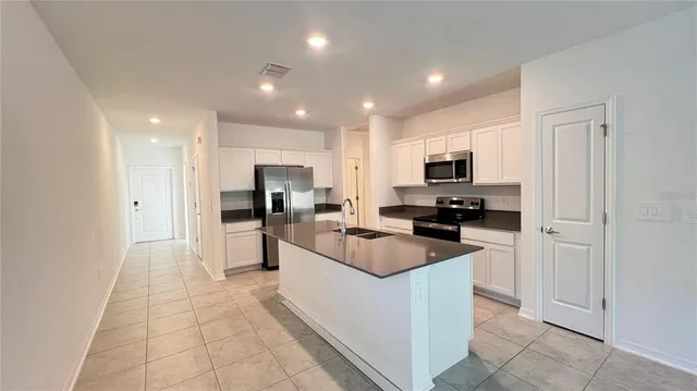 a kitchen with cabinets and stainless steel appliances