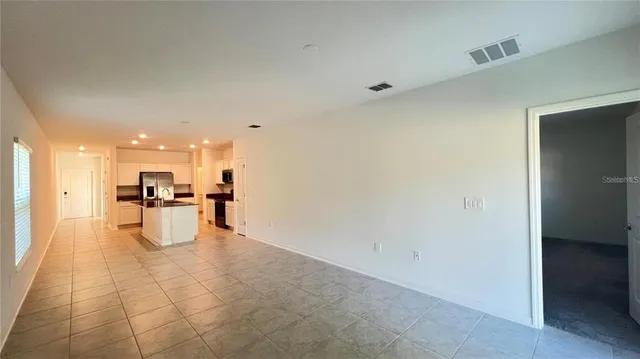 a room with white cabinets and white appliances