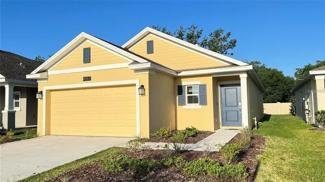 a view of a house with a yard and garage