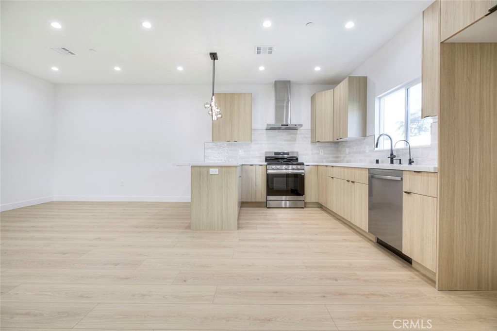 2242 North Keystone Street Burbank, CA 91504 - Photo 6 of 26 a large kitchen with stainless steel appliances granite countertop a stove top oven a sink and a microwave