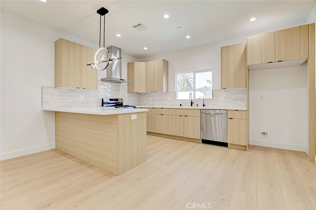 2242 North Keystone Street Burbank, CA 91504 - Photo 7 of 26 a kitchen with stainless steel appliances granite countertop a sink a stove and a refrigerator