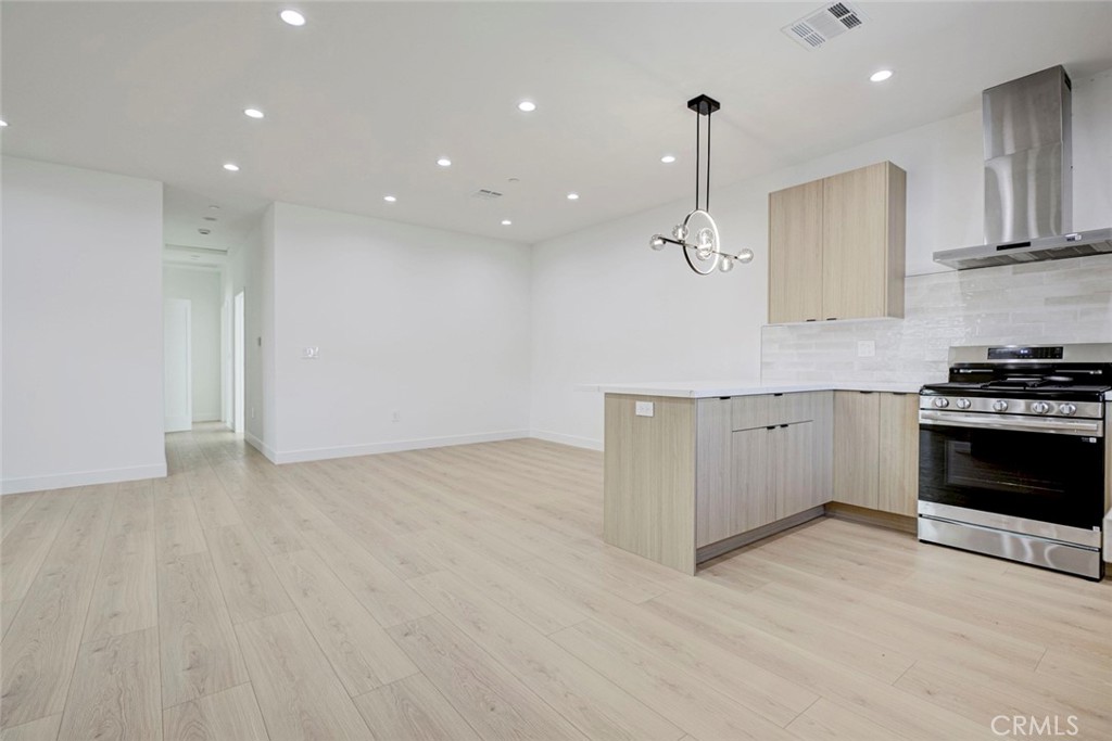 2242 North Keystone Street Burbank, CA 91504 - Photo 9 of 26 a kitchen with stainless steel appliances granite countertop a stove a sink and a refrigerator