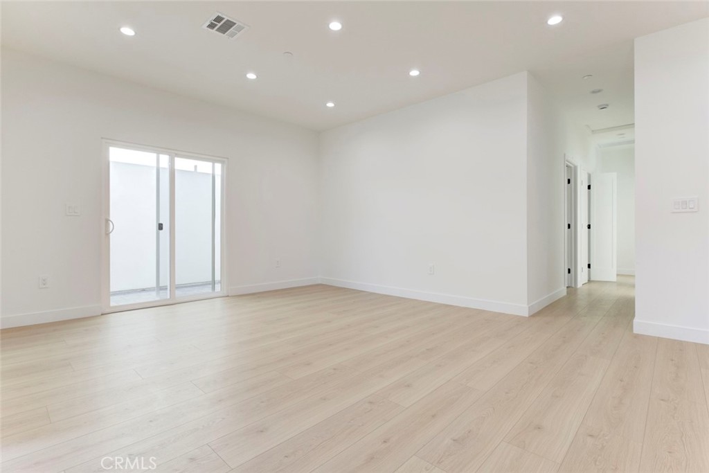 2242 North Keystone Street Burbank, CA 91504 - Photo 10 of 26 an empty room with wooden floor and windows