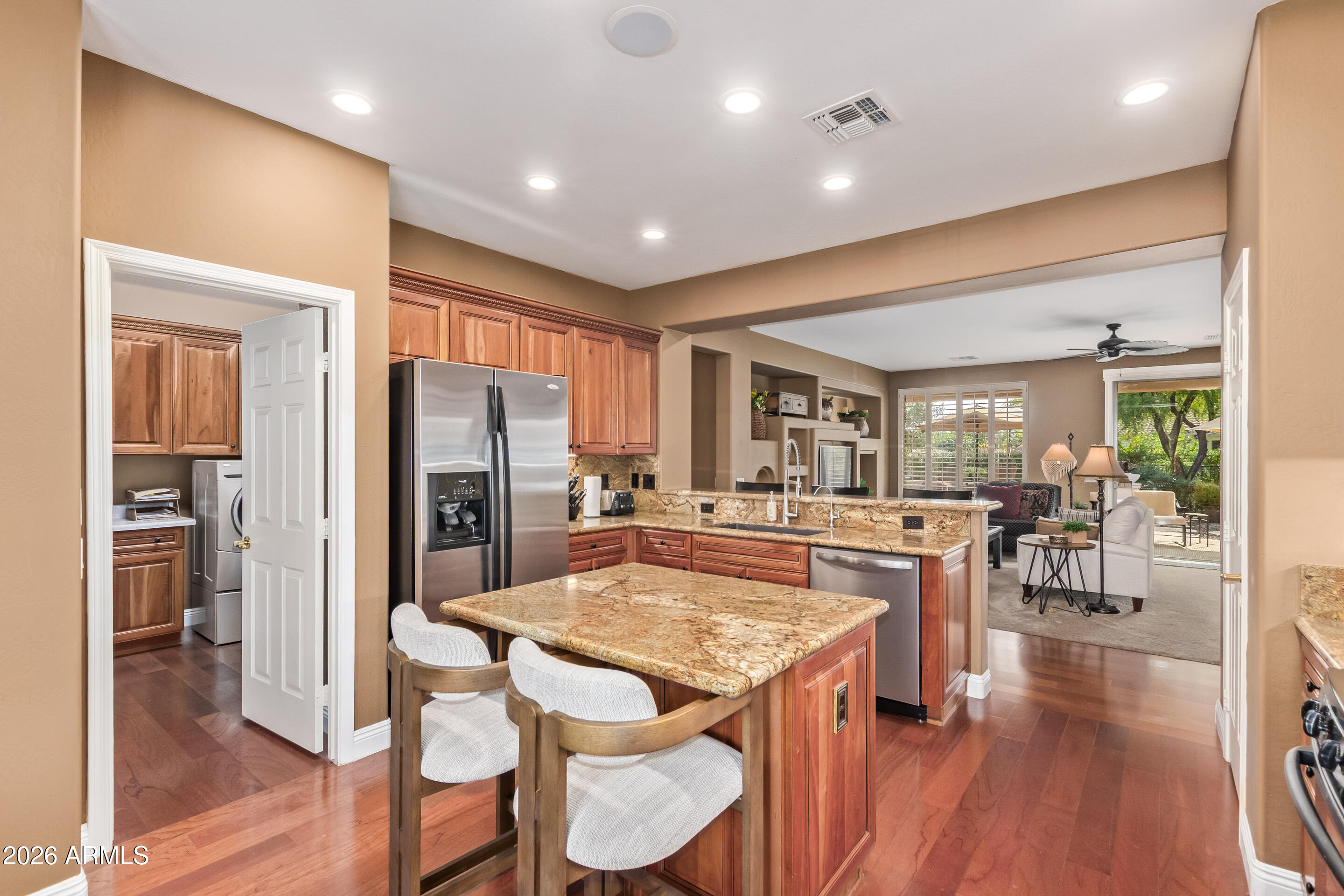 16287 West Cheery Lynn Road Goodyear, AZ 85395 - Photo 15 of 44 a kitchen with stainless steel appliances granite countertop table chairs refrigerator and stove