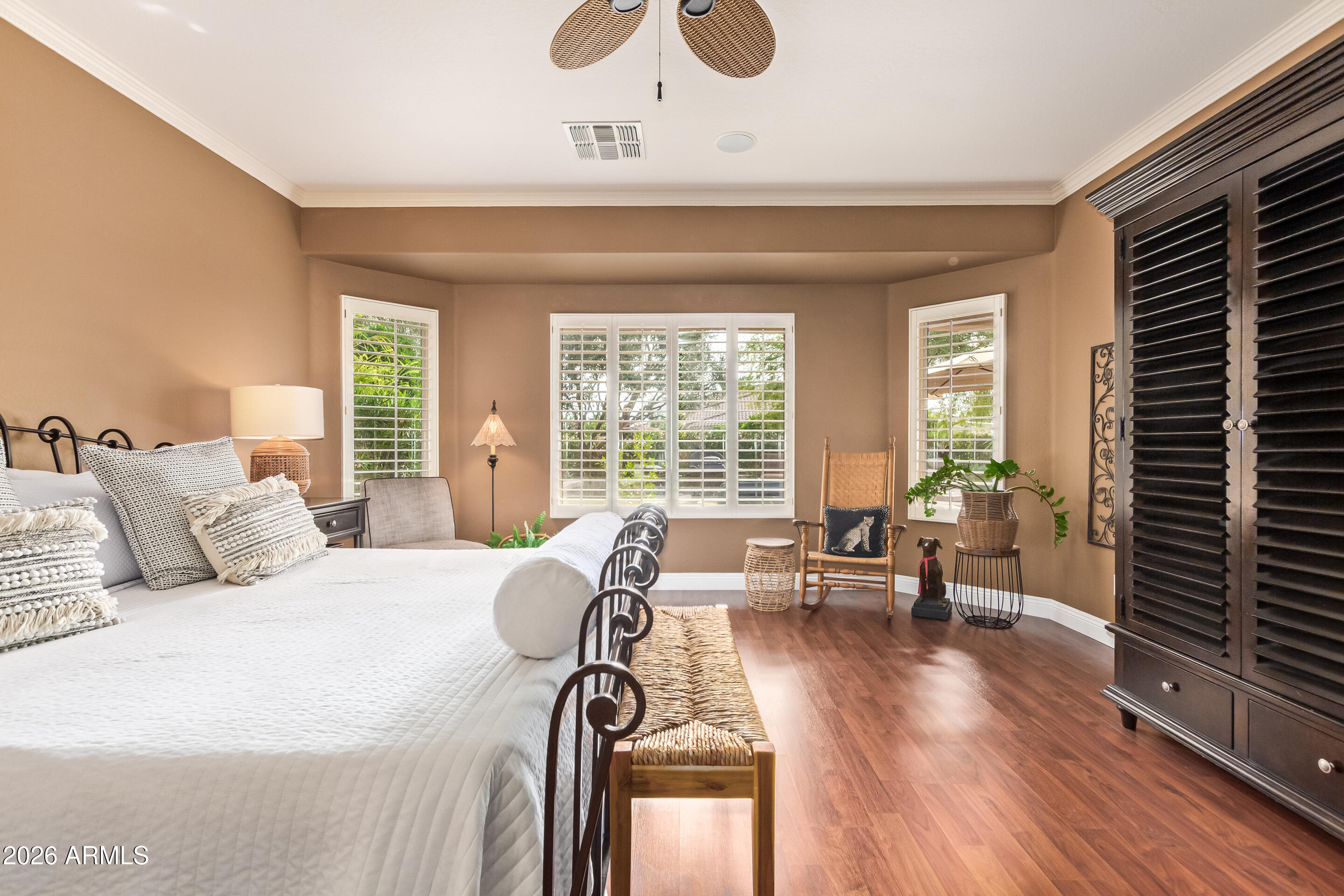 16287 West Cheery Lynn Road Goodyear, AZ 85395 - Photo 18 of 44 a spacious bedroom with a bed a couch and large windows