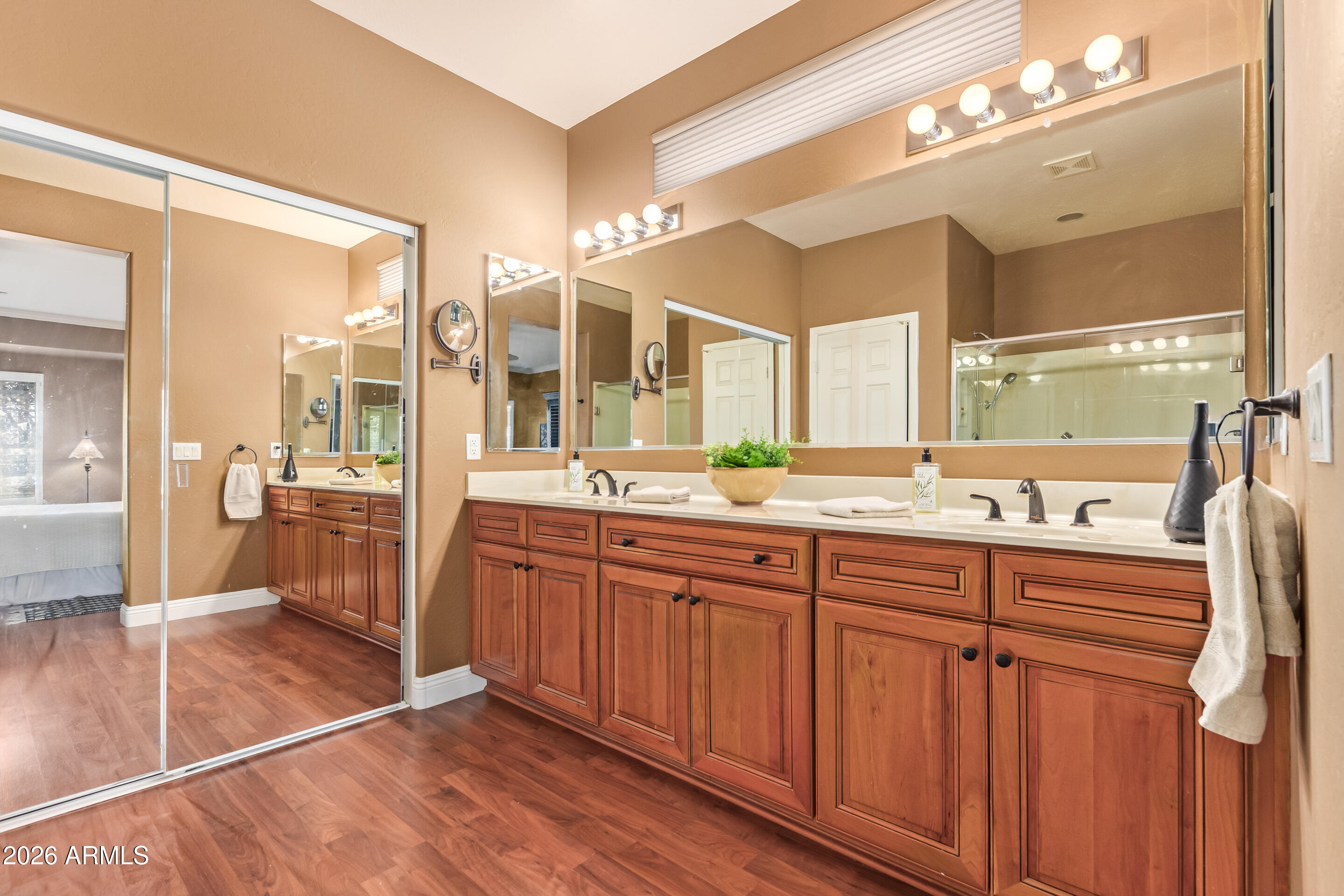 16287 West Cheery Lynn Road Goodyear, AZ 85395 - Photo 19 of 44 a spacious bathroom with a double vanity sink a mirror and a shower