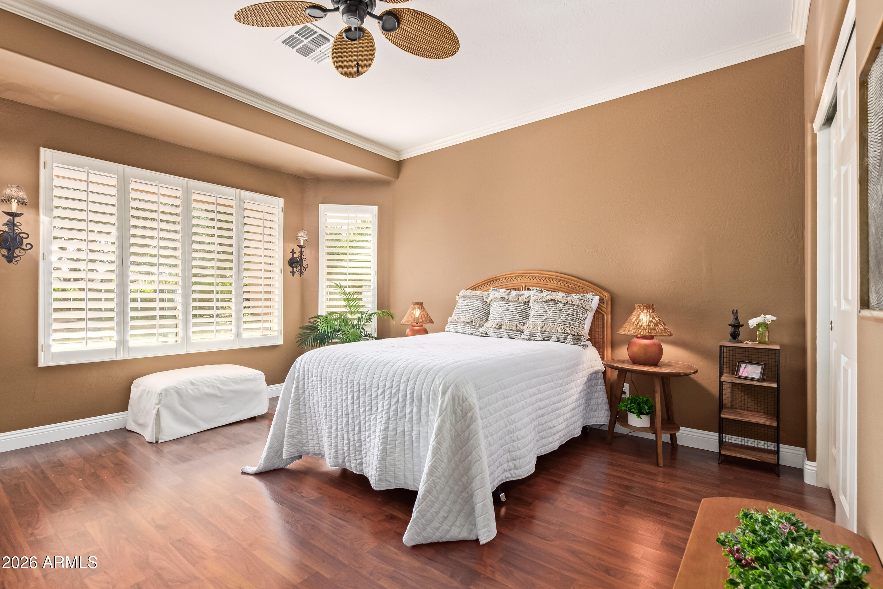 16287 West Cheery Lynn Road Goodyear, AZ 85395 - Photo 21 of 44 a bedroom with a bed and a chandelier