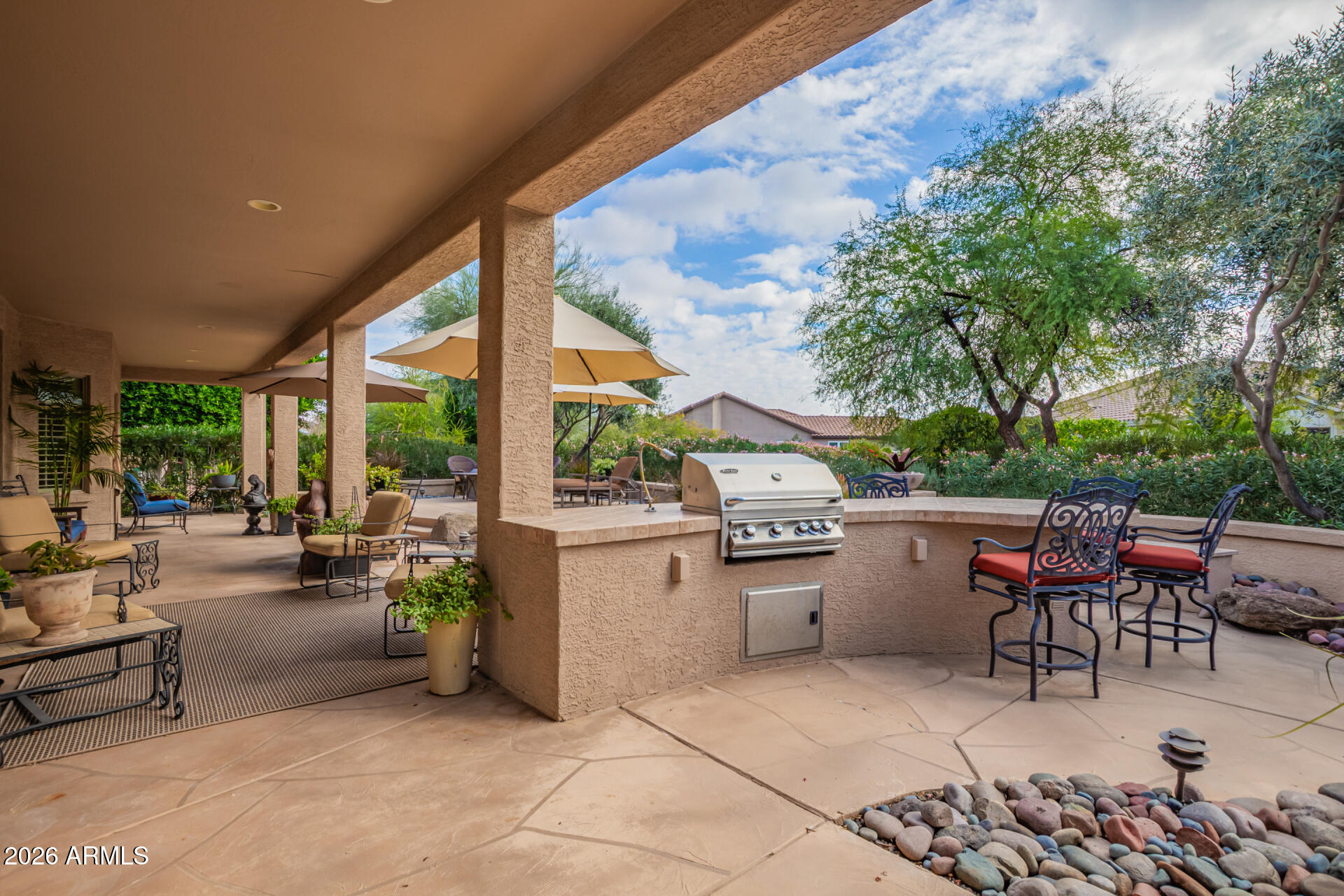 16287 West Cheery Lynn Road Goodyear, AZ 85395 - Photo 26 of 44 a view of a patio with couches and chairs under an umbrella