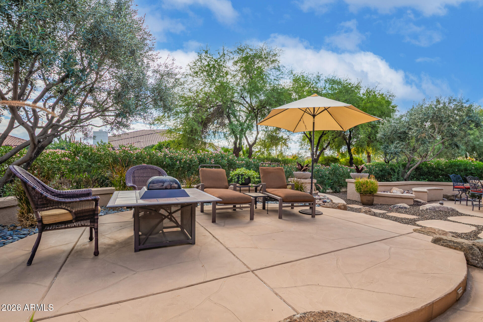 16287 West Cheery Lynn Road Goodyear, AZ 85395 - Photo 27 of 44 a view of a patio with a table and chairs under an umbrella