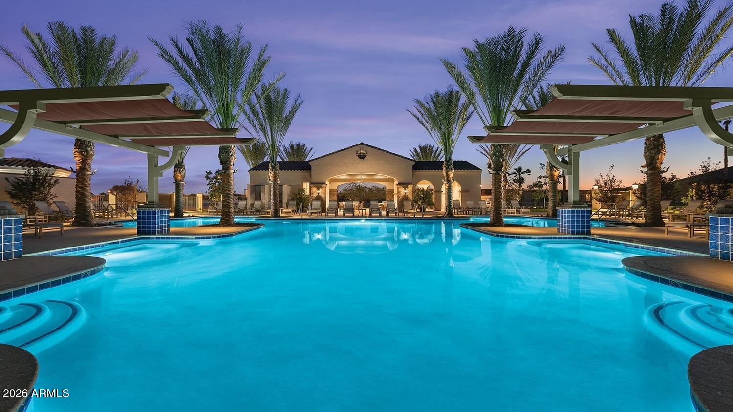 16287 West Cheery Lynn Road Goodyear, AZ 85395 - Photo 35 of 44 a view of a swimming pool with a table and chairs under an umbrella