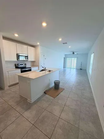 a kitchen with stainless steel appliances a refrigerator sink and microwave