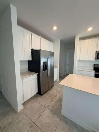 a kitchen with a refrigerator and a sink