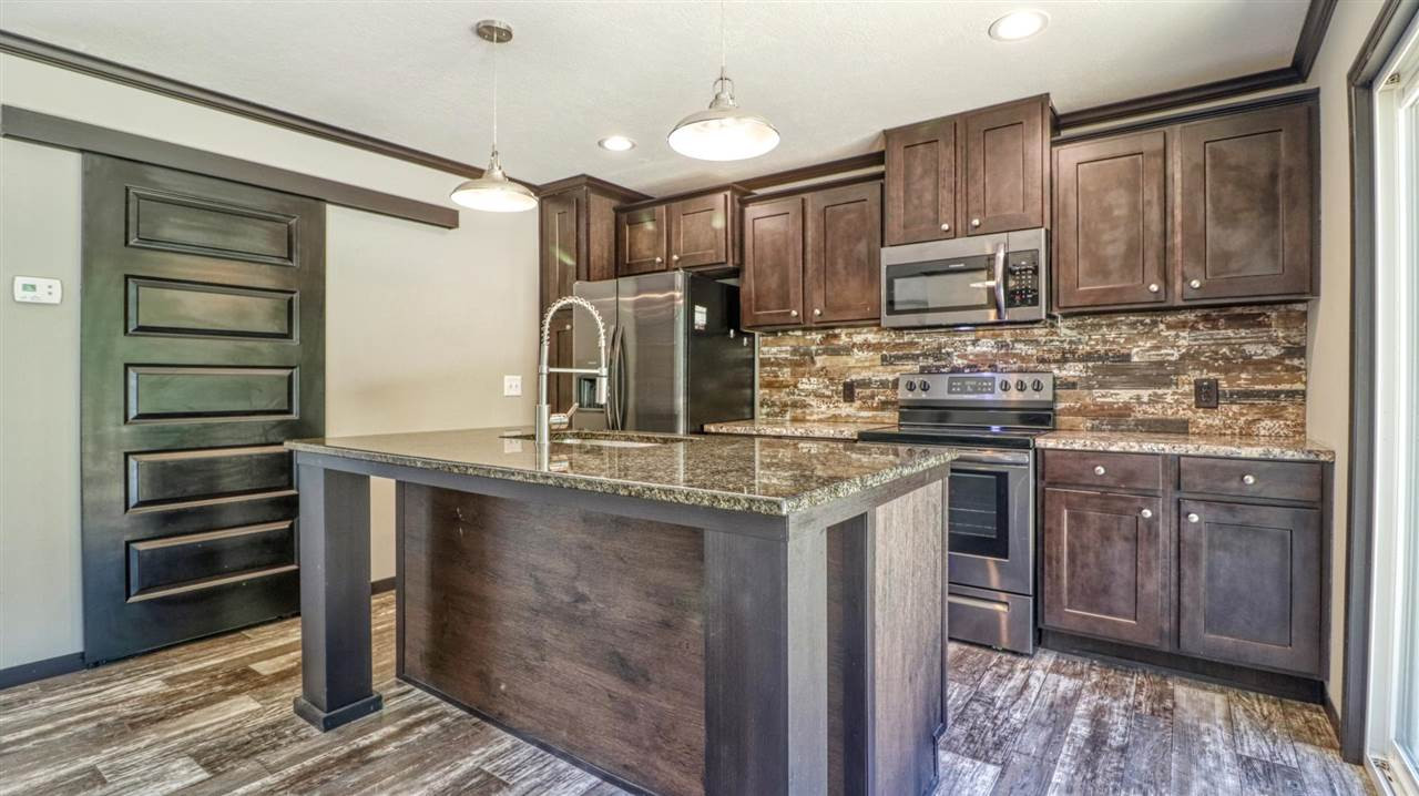 405 Lowery Road Medon, TN 38356 - Photo 10 of 24 a kitchen with stainless steel appliances granite countertop a sink stove and refrigerator